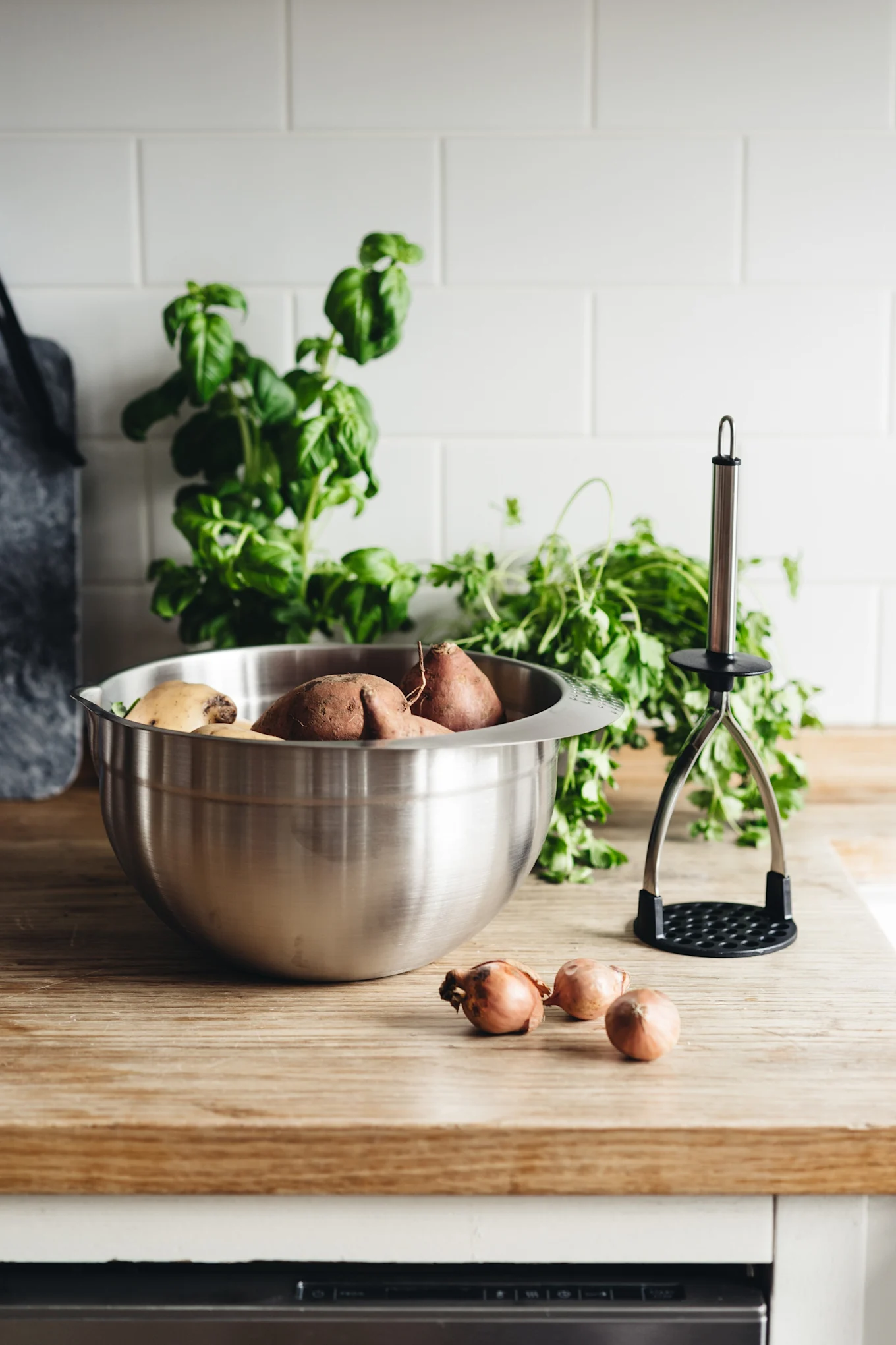 Blandningsskålen från De Buyer står på en köksbänk i trä och är fylld med sötpotatis.